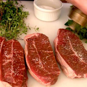 A plate of food on a table, with Steak