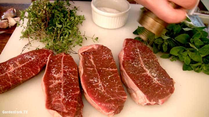 A plate of food on a table, with Steak