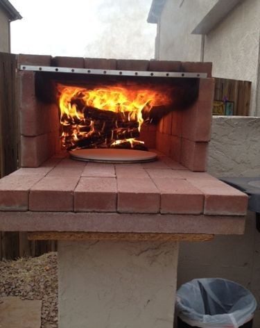 brick pizza oven with pizza baking in it