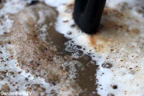 Cleaning cast iron with a battery charger