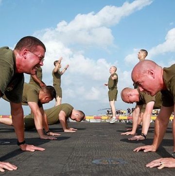 A group of people exercising in a parking lot