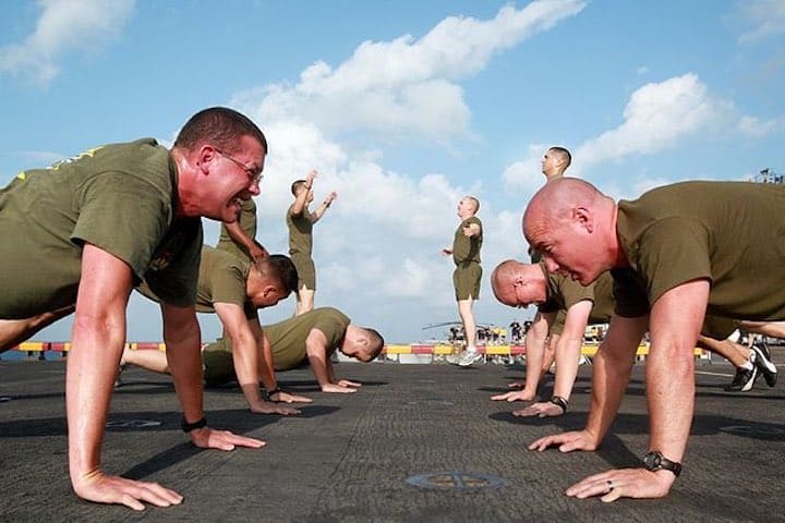 A group of people exercising in a parking lot