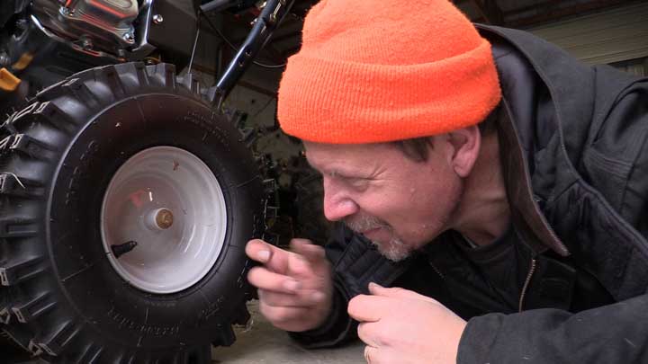 Eric Rochow next to tire