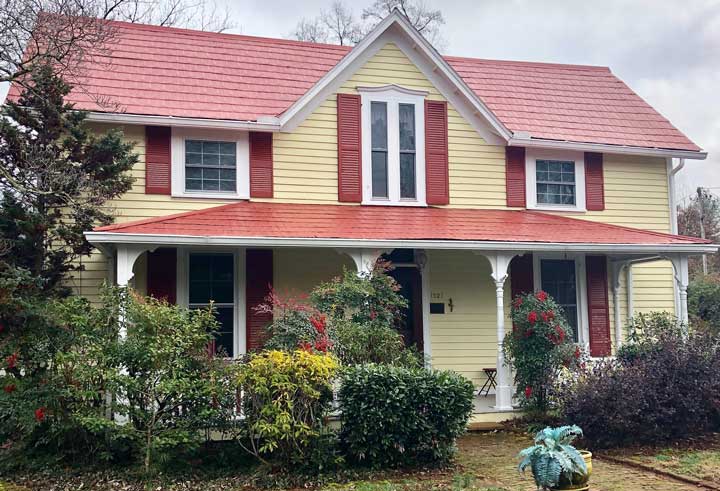 A house with bushes in front